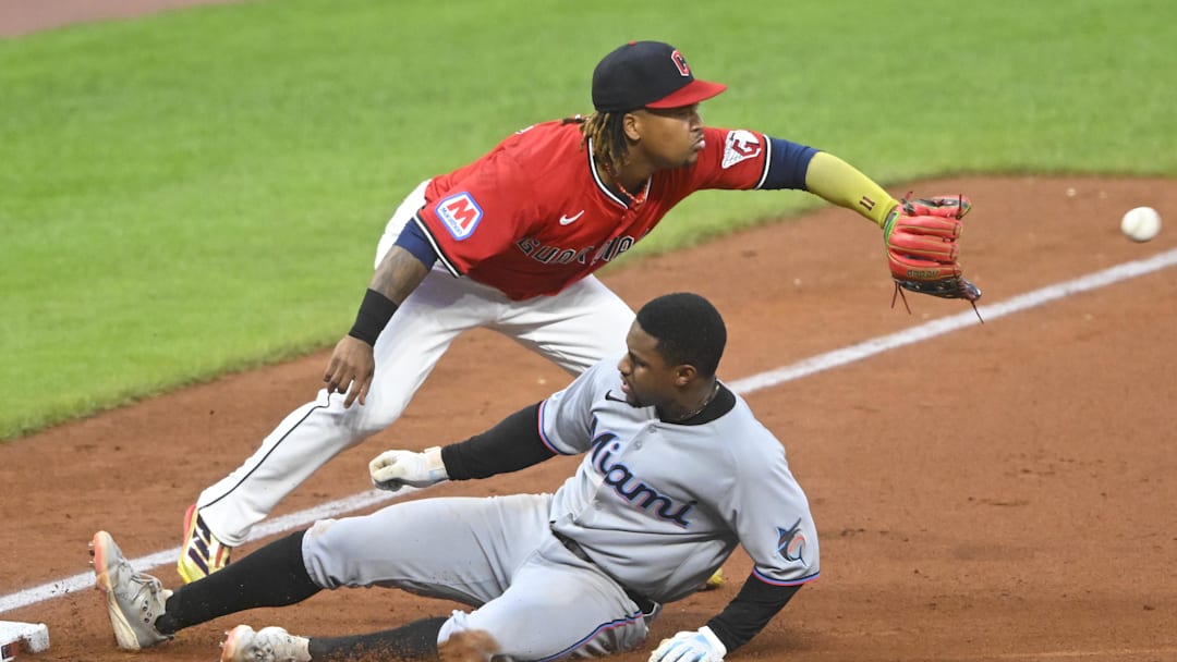 Aug 13, 2025; Cleveland, Ohio, USA; Miami Marlins second baseman Xavier Edwards (9) slides to third base with a triple beside Cleveland Guardians third baseman Jose Ramirez (11) in the sixth inning at Progressive Field. Mandatory Credit: David Richard-Imagn Images