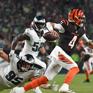Aug 7, 2025; Philadelphia, Pennsylvania, USA; Cincinnati Bengals quarterback Desmond Ridder (4) is pressured by Philadelphia Eagles defensive tackle Ty Robinson (95) during the third quarter at Lincoln Financial Field. Mandatory Credit: Eric Hartline-Imagn Images