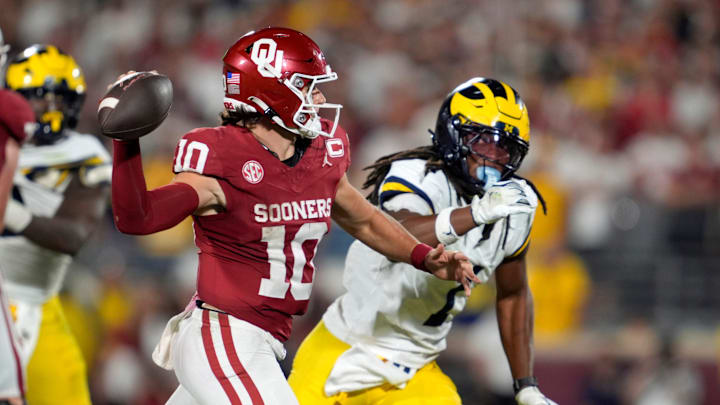 Oklahoma Sooners quarterback John Mateer (10) throws as Michigan Wolverines linebacker Jaishawn Barham (1) chases Oklahoma Sooners quarterback John Mateer (10) throws as Michigan Wolverines linebacker Jaishawn Barham (1) chases