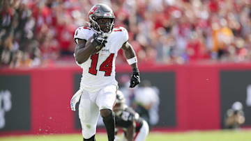 Oct 22, 2023; Tampa, Florida, USA;  Tampa Bay Buccaneers wide receiver Chris Godwin (14) runs with the ball against the Atlanta Falcon in the fourth quarter at Raymond James Stadium. Mandatory Credit: Nathan Ray Seebeck-Imagn Images