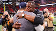 Atlanta Falcons head coach Raheem Morris embraces Seahawks head coach Mike MacDonald after being blown out 37-9