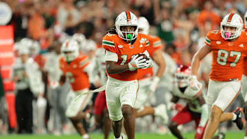 Oct 17, 2025; Miami Gardens, Florida, USA; Miami Hurricanes wide receiver Malachi Toney (10) carries the football against the Louisville Cardinals during the second quarter at Hard Rock Stadium. Mandatory Credit: Sam Navarro-Imagn Images