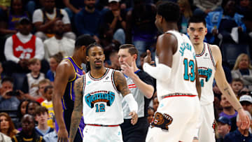 Mar 29, 2025; Memphis, Tennessee, USA; Memphis Grizzlies guard Ja Morant (12) reacts with forward Jaren Jackson Jr. (13) during the first quarter against the Los Angeles Lakers at FedExForum. Mandatory Credit: Petre Thomas-Imagn Images