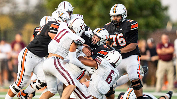 A group of defenders wrap up Valley quarterback Drake DeGroote (15) during a high school football game between Valley and Dowling Catholic on Aug. 29, 2025, at Valley Stadium in West Des Moines, Iowa. Valley defeated Dowling Catholic 20-19. A group of defenders wrap up Valley quarterback Drake DeGroote (15) during a high school football game between Valley and Dowling Catholic on Aug. 29, 2025, at Valley Stadium in West Des Moines, Iowa. Valley defeated Dowling Catholic 20-19.