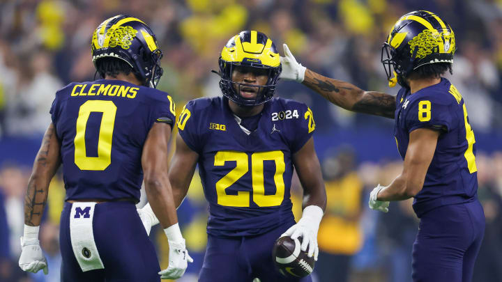 Jan 8, 2024; Houston, TX, USA; Michigan Wolverines defensive back Mike Sainristil (0) and linebacker Derrick Moore (8) celebrates defensive back Jyaire Hill (20) defensive play against the Washington Huskies in the 2024 College Football Playoff national championship game at NRG Stadium.