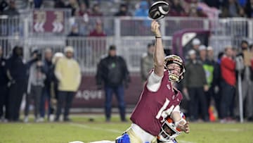 Nov 30, 2024; Tallahassee, Florida, USA; Florida State Seminoles quarterback Luke Kromenhoek (14) is pressured by Florida Gators linebacker Myles Graham (5) during the second half at Doak S. Campbell Stadium. Mandatory Credit: Melina Myers-Imagn Images