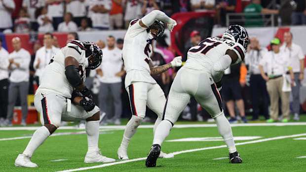 Houston Texans safety Jalen Pitre (5) celebrates a sack by Houston Texans defensive end Will Anderson Jr. (51) 
