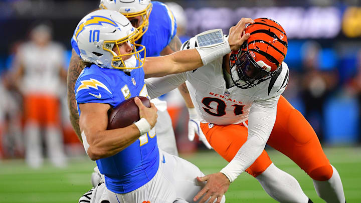 Nov 17, 2024; Inglewood, California, USA; Los Angeles Chargers quarterback Justin Herbert (10) is brought down by Cincinnati Bengals defensive end Trey Hendrickson (91) during the first half at SoFi Stadium. Nov 17, 2024; Inglewood, California, USA; Los Angeles Chargers quarterback Justin Herbert (10) is brought down by Cincinnati Bengals defensive end Trey Hendrickson (91) during the first half at SoFi Stadium.