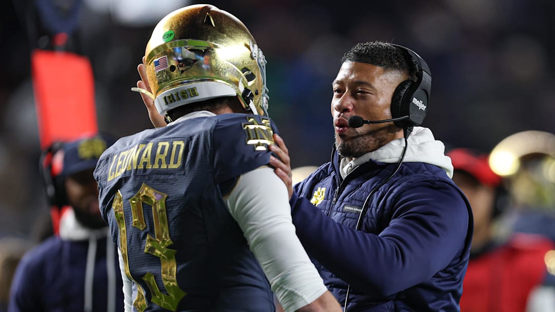 Nov 23, 2024; New York, New York, USA; Notre Dame Fighting Irish head coach Marcus Freeman celebrates with quarterback Riley Leonard (13) after a touchdown during the first half against the Army Black Knights at Yankee Stadium. Mandatory Credit: Vincent Carchietta-Imagn Images