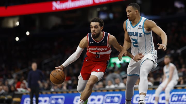 Mar 8, 2024; Washington, District of Columbia, USA; Washington Wizards guard Tyus Jones (5) drives to the basket as Charlotte Hornets forward Grant Williams (2) defends in the first half at Capital One Arena. Mandatory Credit: Geoff Burke-USA TODAY Sports