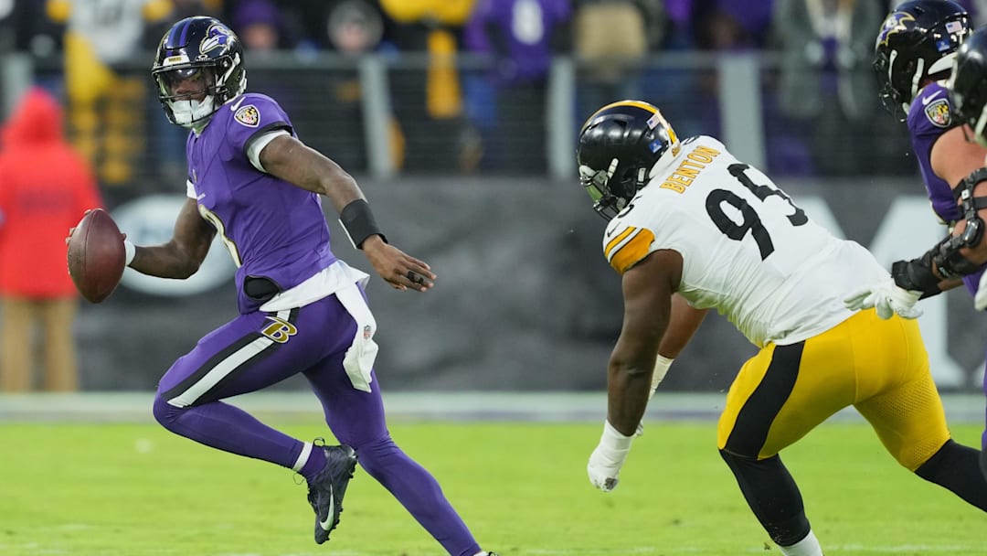 Dec 21, 2024; Baltimore, Maryland, USA; Baltimore Ravens quarterback Lamar Jackson (8) scrambles during the first quarter pressured by Pittsburgh Steelers tackle Keeanu Benton (95) at M&T Bank Stadium. Mandatory Credit: Mitch Stringer-Imagn Images