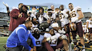 Oct 21, 2023; Iowa City, Iowa, USA; The Minnesota Golden Gophers hold the Floyd of Rosedale trophy after the game against the Iowa Hawkeyes at Kinnick Stadium. Mandatory Credit: Jeffrey Becker-Imagn Images