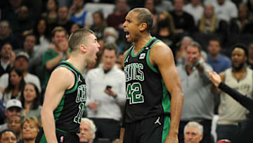 May 9, 2022; Milwaukee, Wisconsin, USA; Boston Celtics center Al Horford (42), right yells out after being fouled along with Boston Celtics guard Payton Pritchard (11) in the second half during game four of the second round for the 2022 NBA playoffs at Fiserv Forum. Mandatory Credit: Michael McLoone-Imagn Images
