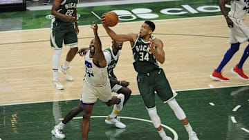 Apr 24, 2021; Milwaukee, Wisconsin, USA;  Milwaukee Bucks forward Giannis Antetokounmpo (34) grabs a rebound in front of Philadelphia 76ers center Dwight Howard (39) in the second quarter at Fiserv Forum. Mandatory Credit: Michael McLoone-Imagn Images