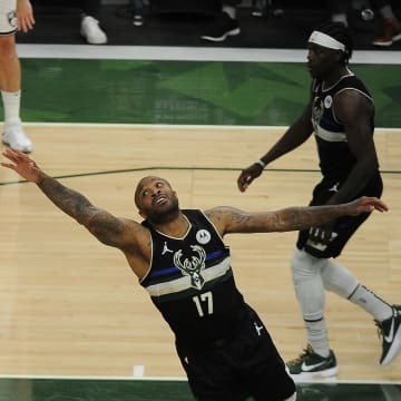 Jun 17, 2021; Milwaukee, Wisconsin, USA; Brooklyn Nets forward Kevin Durant (7) puts up a shot against Milwaukee Bucks forward P.J. Tucker (17) in the third quarter during game six in the second round of the 2021 NBA Playoffs at Fiserv Forum. Mandatory Credit: Michael McLoone-USA TODAY Sports