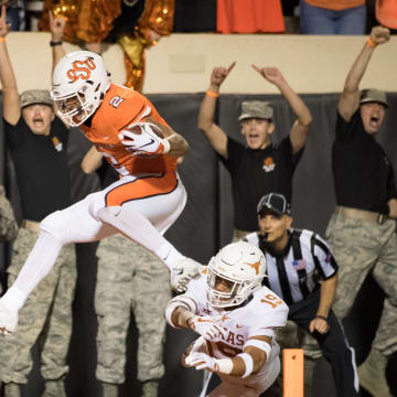 Oct 27, 2018; Stillwater, OK, USA; Oklahoma State Cowboys wide receiver Tylan Wallace (2) touchdown while defended by Texas Longhorns defensive back Brandon Jones (19) during the first half at Boone Pickens Stadium. Mandatory Credit: Rob Ferguson-USA TODAY Sports