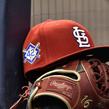 Apr 15, 2019; Milwaukee, WI, USA; A cap rests on the dug out wall with the number 42 on the hat in honor of Major League Baseball   s Jackie Robinson Day. Mandatory Credit: Michael McLoone-Imagn Images