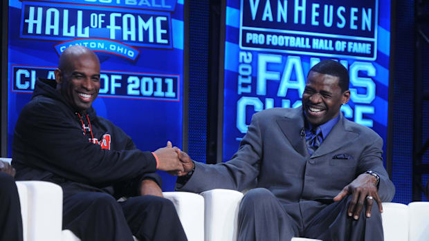 Feb 5, 2011; Dallas, TX, USA; Deion Sanders (left) and Michael Irvin at the 2011 Pro Football Hall of Fame announcement show 