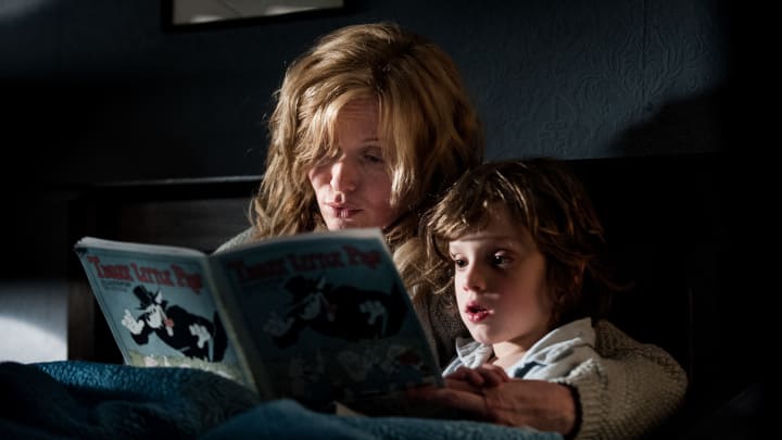 A mother and son read a storybook together at bedtime