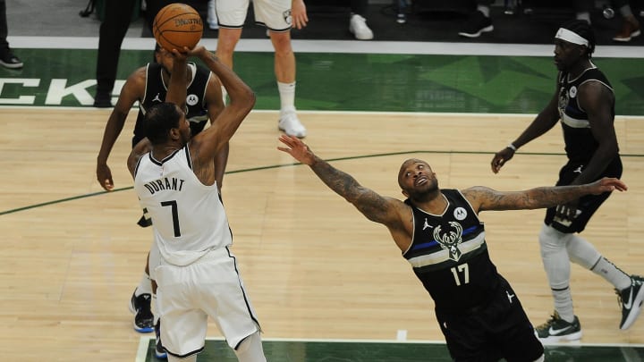 Jun 17, 2021; Milwaukee, Wisconsin, USA; Brooklyn Nets forward Kevin Durant (7) puts up a shot against Milwaukee Bucks forward P.J. Tucker (17) in the third quarter during game six in the second round of the 2021 NBA Playoffs at Fiserv Forum. Mandatory Credit: Michael McLoone-USA TODAY Sports