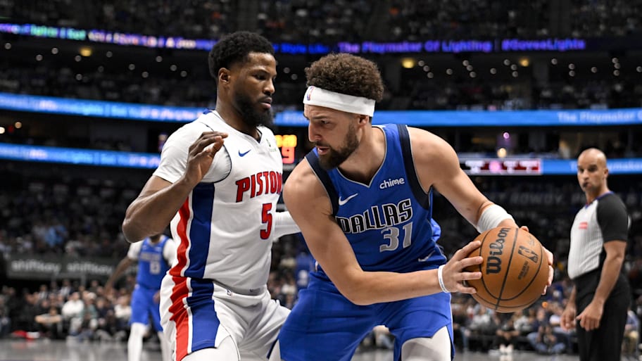 Dallas Mavericks guard Klay Thompson (31) looks to move the ball past Detroit Pistons guard Malik Beasley. | Jerome Miron-Imagn Images