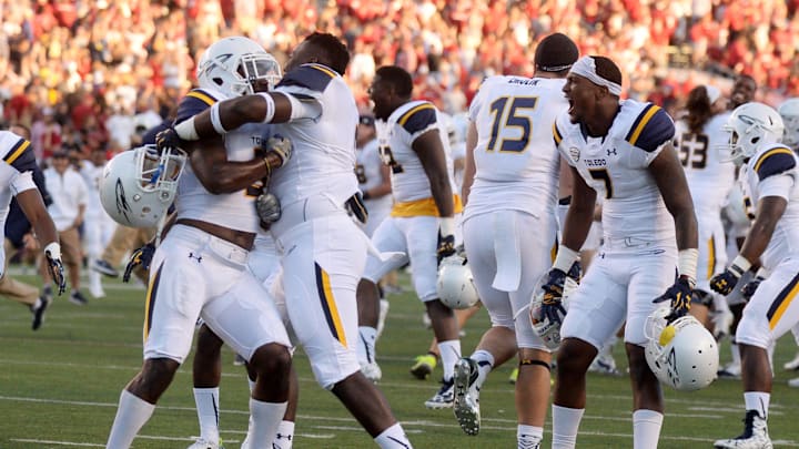 The Toledo Rockets celebrate against the Arkansas Razorbacks at War Memorial Stadium. 