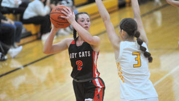 New London's Raeann Mitchell tries to get a shot up with Colonel Crawford's Lila Plesac pressuring.