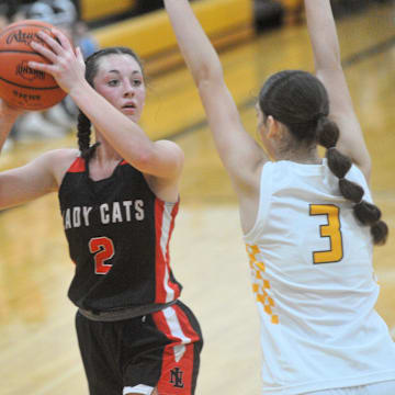 New London's Raeann Mitchell tries to get a shot up with Colonel Crawford's Lila Plesac pressuring.