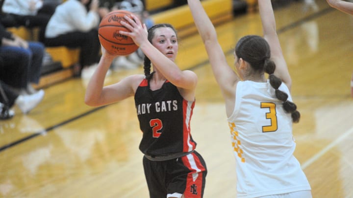 New London's Raeann Mitchell tries to get a shot up with Colonel Crawford's Lila Plesac pressuring.