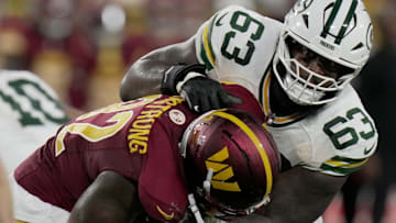 Green Bay Packers offensive tackle Rasheed Walker (63) blocks Washington Commanders defensive end Dorance Armstrong (92) during the second quarter of their game Thursday, September 11, 2025 at Lambeau Field in Green Bay, Wisconsin.