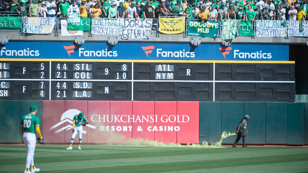 Sep 26, 2024; Oakland, California, USA; Oakland Athletics outfielder Lawrence Butler (4) reacts to smoke bombs being thrown on the field during the ninth inning of the game against the Texas Rangers at Oakland-Alameda County Coliseum. Mandatory Credit: Ed Szczepanski-Imagn Images