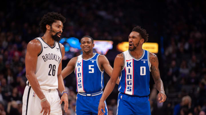 Dec 11, 2023; Sacramento, California, USA; Brooklyn Nets guard Spencer Dinwiddie (26) and Sacramento Kings guard Malik Monk (0) and guard De'Aaron Fox (5) discuss the previous play during the third quarter at Golden 1 Center. Mandatory Credit: Ed Szczepanski-USA TODAY Sports