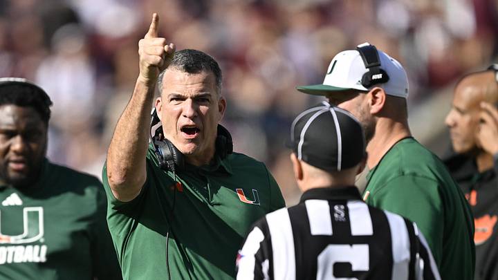 Dec 20, 2025; College Station, TX, USA; Miami Hurricanes head coach Mario Cristobal talks with an official during the second half of the first round game of the CFP National Playoff against the Texas A&M Aggies at Kyle Field. Mandatory Credit: Jerome Miron-Imagn Images