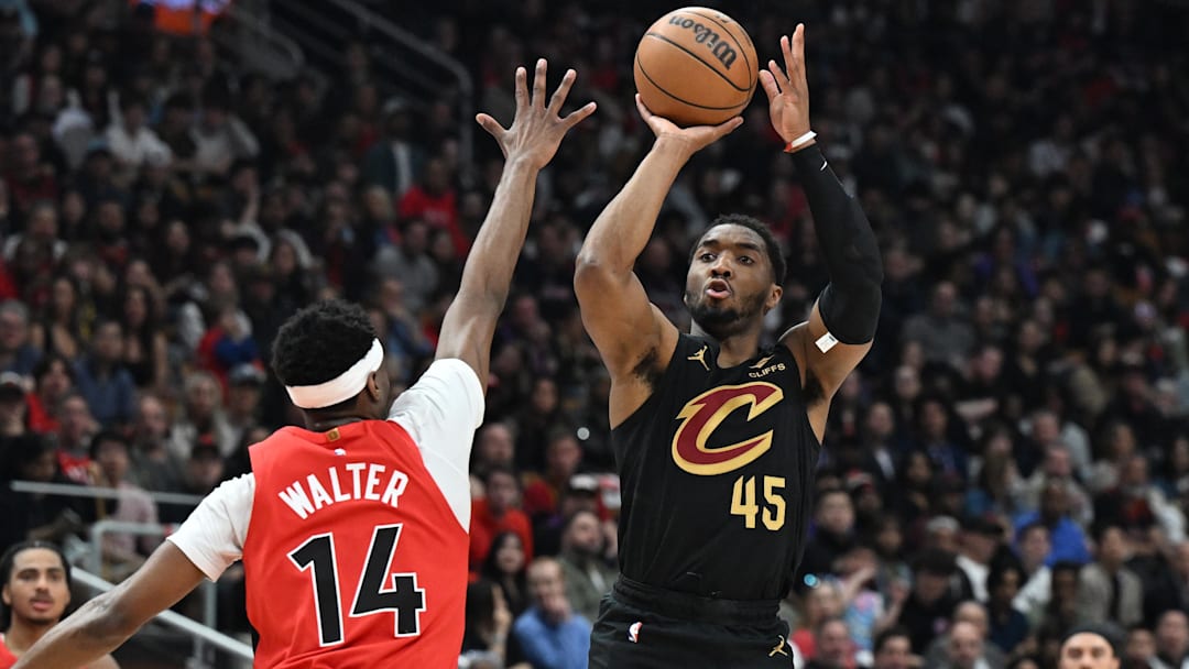 Apr 26, 2026; Toronto, Ontario, CAN;  Cleveland Cavaliers guard Donovan Mitchell (45) shoots the ball against Toronto Raptors guard Ja'Kobe Walter (14) during game four of the first round of the 2026 NBA Playoffs at Scotiabank Arena. Mandatory Credit: Dan Hamilton-Imagn Images