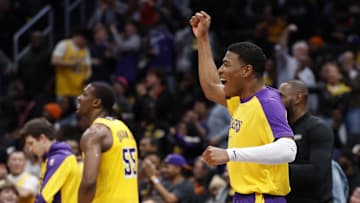 Jan 30, 2025; Washington, District of Columbia, USA; Los Angeles Lakers forward Rui Hachimura (R) reacts on the bench after a basket by Lakers guard Bronny James (not pictured) against the Washington Wizards in the fourth quarter at Capital One Arena. Mandatory Credit: Geoff Burke-Imagn Images