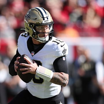 Jan 5, 2025; Tampa, Florida, USA; New Orleans Saints quarterback Spencer Rattler (18) drops back to passs against the Tampa Bay Buccaneers in the first quarter  at Raymond James Stadium. Mandatory Credit: Nathan Ray Seebeck-Imagn Images