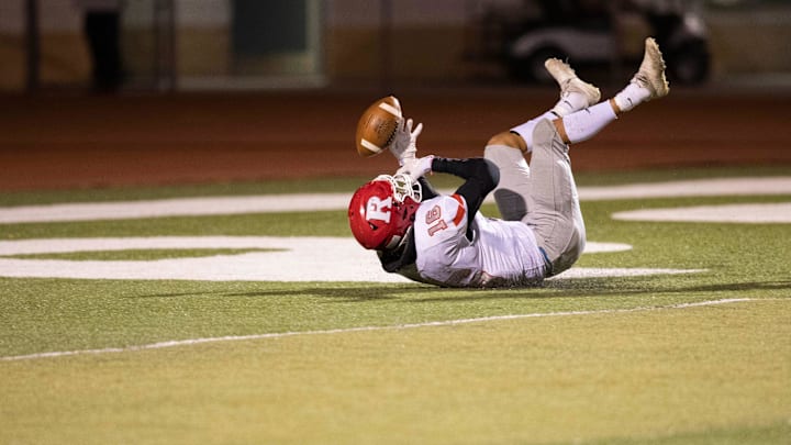 Roswell free safety Xai Carrasco fumbles a catch during a high school football game at the Field of Dreams.