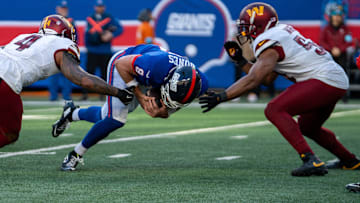 New York Giants quarterback Daniel Jones (8) attempts to score on a 2-point conversion before being tackled by Washington Commanders linebacker Frankie Luvu (4) during a game between the New York Giants and the Washington Commanders at MetLife Stadium in East Rutherford on Sunday, Nov. 3, 2024.