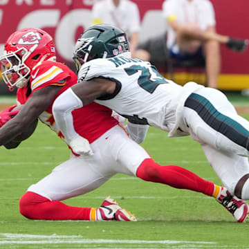 Sep 14, 2025; Kansas City, Missouri, USA; Philadelphia Eagles safety Andrew Mukuba (24) tackles Kansas City Chiefs wide receiver Hollywood Brown (5) during the third quarter of the game at GEHA Field at Arrowhead Stadium. Mandatory Credit: Denny Medley-Imagn Images