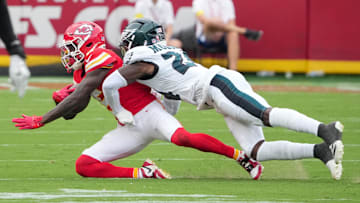 Sep 14, 2025; Kansas City, Missouri, USA; Philadelphia Eagles safety Andrew Mukuba (24) tackles Kansas City Chiefs wide receiver Hollywood Brown (5) during the third quarter of the game at GEHA Field at Arrowhead Stadium. Mandatory Credit: Denny Medley-Imagn Images