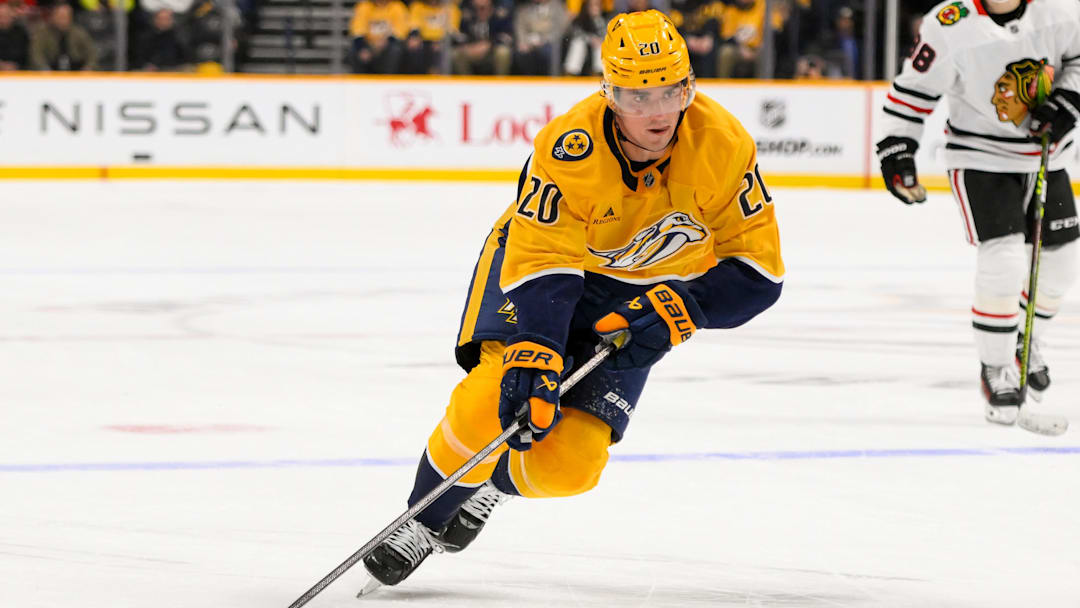 Jan 16, 2025; Nashville, Tennessee, USA;  Nashville Predators defenseman Justin Barron (20) skates with the puck against the Chicago Blackhawks during the third period at Bridgestone Arena. Mandatory Credit: Steve Roberts-Imagn Images