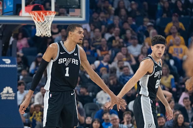 San Antonio Spurs center Victor Wembanyama (1) high-fives forward Zach Collins (23) during the first quarter.