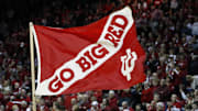 An Indiana Hoosiers cheerleader runs with a flag in support of the Hoosiers during a timeout during the second half at Assembly Hall against Rutgers. The Hoosiers won 72-64.