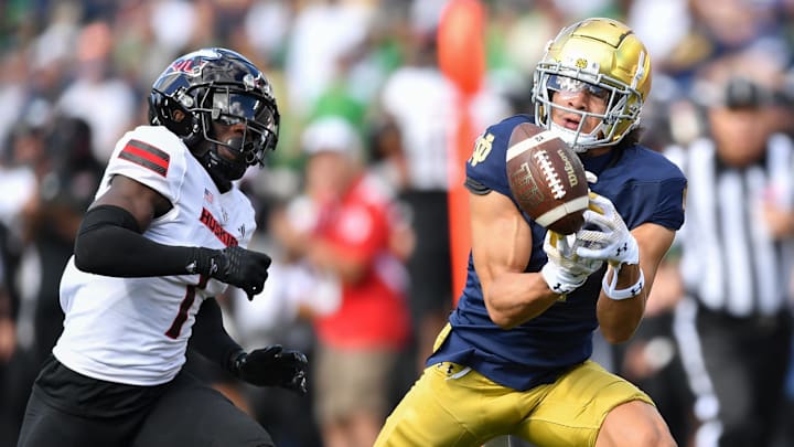 Sep 7, 2024; South Bend, Indiana, USA; Notre Dame Fighting Irish wide receiver Jaden Greathouse (1) attempts to catch a pass as Northern Illinois Huskies defensive back Jashon Prophete (1) defends in the second quarter at Notre Dame Stadium. Mandatory Credit: Matt Cashore-Imagn Images