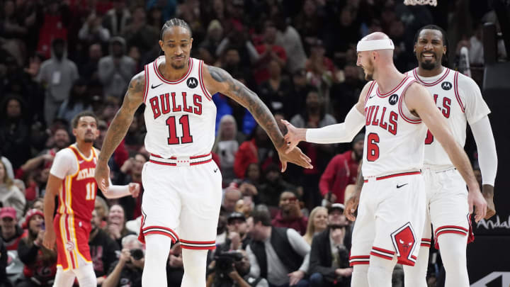 Dec 26, 2023; Chicago, Illinois, USA; Chicago Bulls forward DeMar DeRozan (11) celebrates his three point basket with guard Alex Caruso (6) during the second half against the Atlanta Hawks at United Center. 