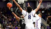 Mar 9, 2024; Fort Worth, Texas, USA; UCF Knights guard Jaylin Sellers (24) shoots past TCU Horned Frogs center Ernest Udeh Jr. (8) during the second half at Ed and Rae Schollmaier Arena. Mandatory Credit: Kevin Jairaj-Imagn Images