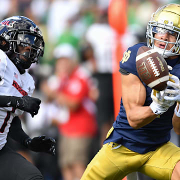 Sep 7, 2024; South Bend, Indiana, USA; Notre Dame Fighting Irish wide receiver Jaden Greathouse (1) attempts to catch a pass as Northern Illinois Huskies defensive back Jashon Prophete (1) defends in the second quarter at Notre Dame Stadium. 