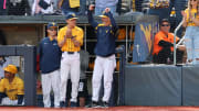 West Virginia head coach Randy Mazey celebrates his final out of his illustrious Mountaineer career with his son Weston standing along his side against Kansas State. 