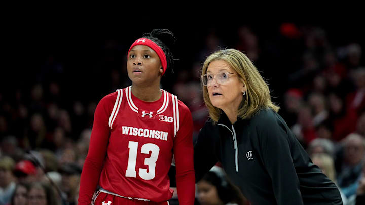 Wisconsin Badgers guard Ronnie Porter (13) speaks with head coach Robin Pingeton in the first half of the NCAA basketball game at Value City Arena on Thursday, Jan. 29, 2026 in Columbus, Ohio.