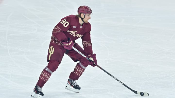 Mar 28, 2024; Tempe, Arizona, USA; Arizona Coyotes defenseman J.J. Moser (90) carries the puck in the first period against the Nashville Predators at Mullett Arena. Mandatory Credit: Matt Kartozian-USA TODAY Sports